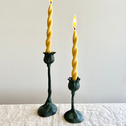 poppy pods taper candle holder 9 inch and 5 inch bronze with lit candle