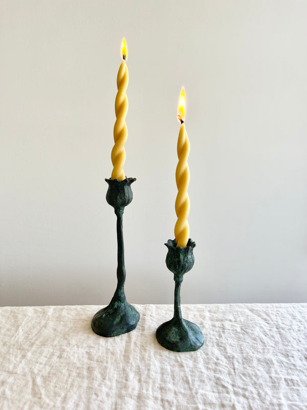 poppy pods taper candle holder 9 inch and 5 inch bronze with lit candle