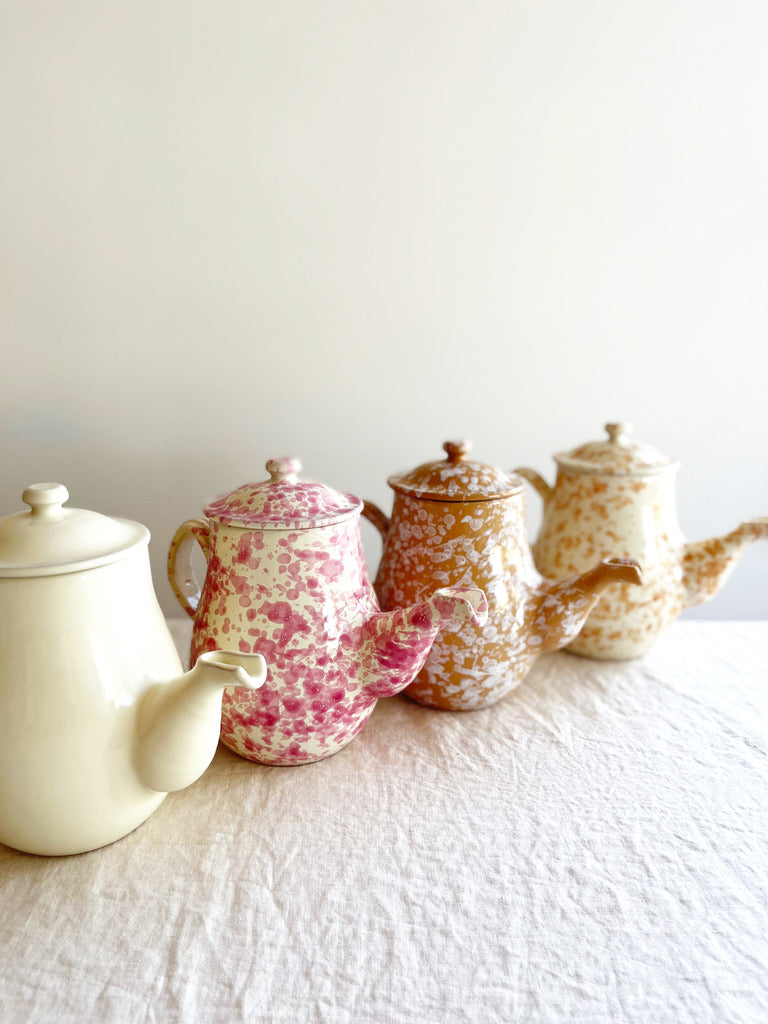 coffee pot with splatter pattern in natural color with other color options on table side view