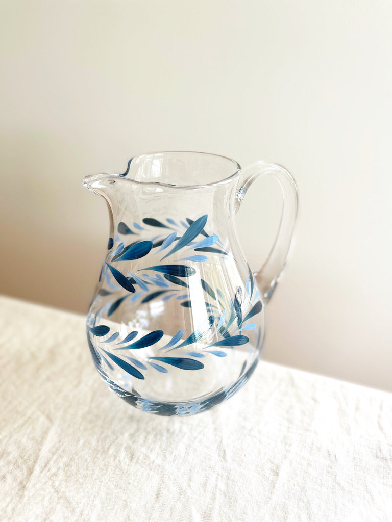 glass pitcher with hand painted blue leaf pattern 8 inches tall angled view