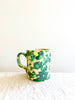 cream mug with green splatter pattern