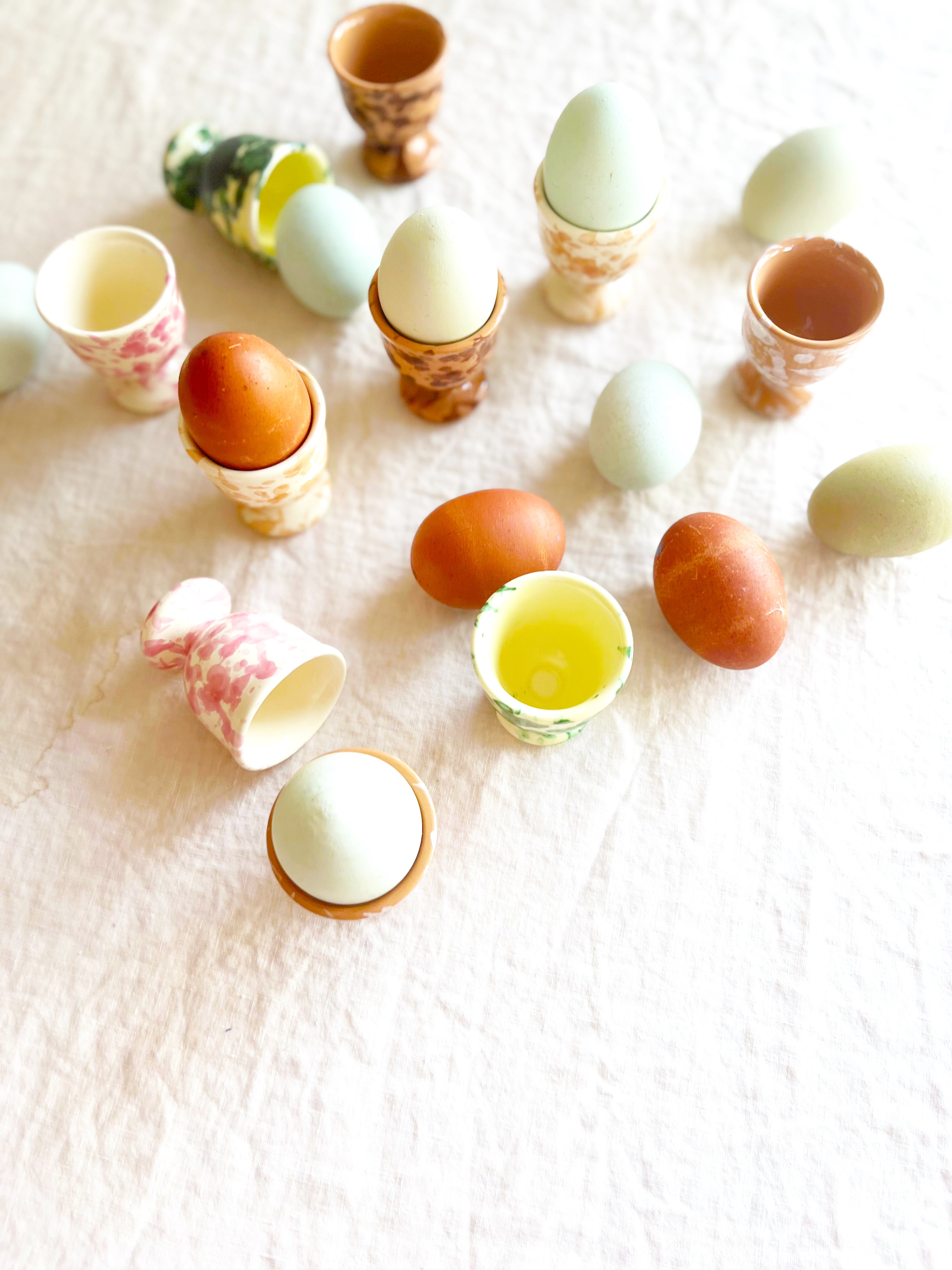 cream egg cups with pink splatter pattern 2 inches in diameter top view