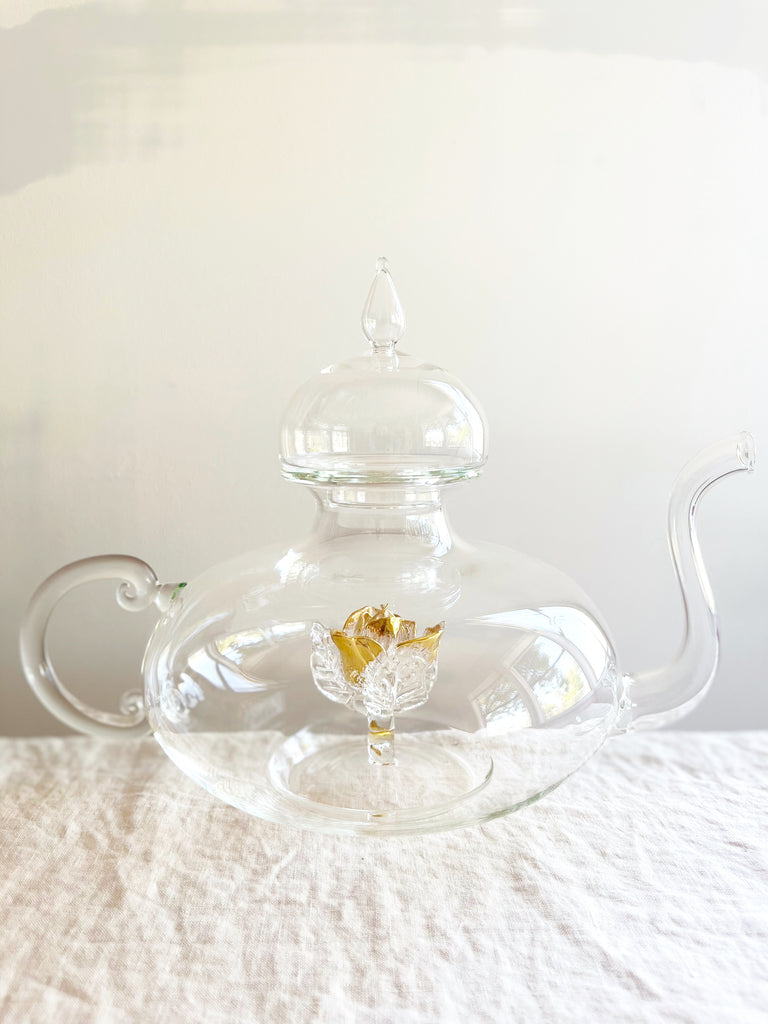 clear hand blown glass teapot with gold glass rose in bottom
