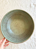 ceramic pasta bowl with peacock design in jade 11 inches in diameter on white table