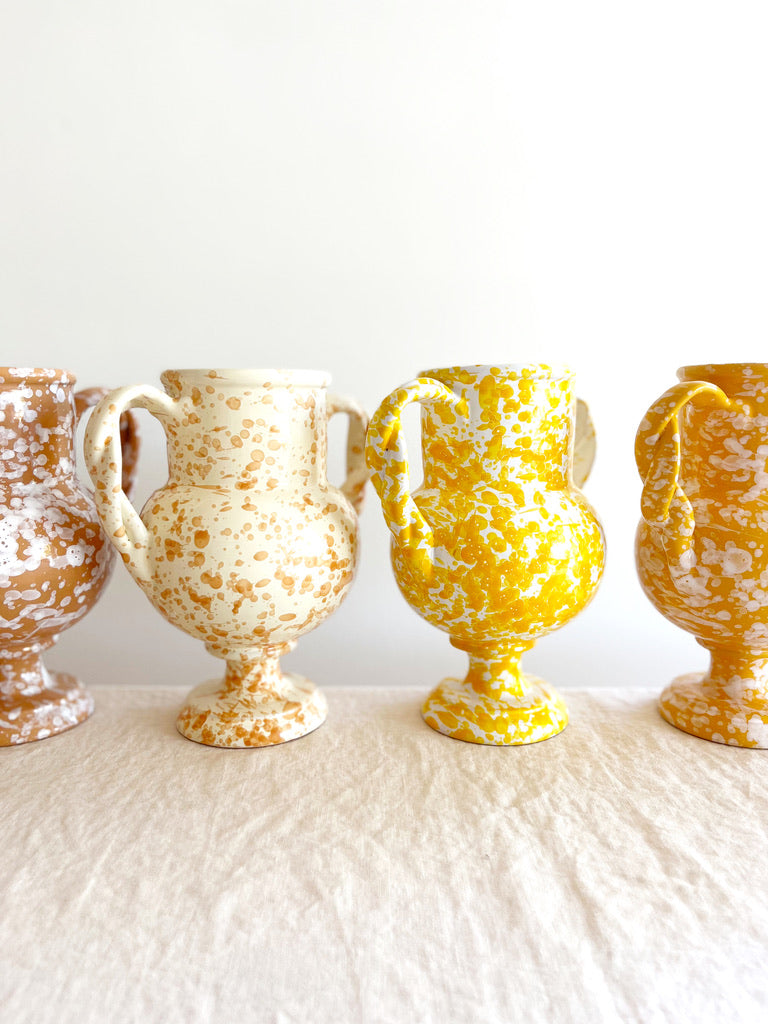 small yellow amphora vase with white speckle pattern 8.25 inches tall in group of four