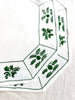 octagonal white linen placemat with olive green embroidery 19.5" by 16" edge detail view