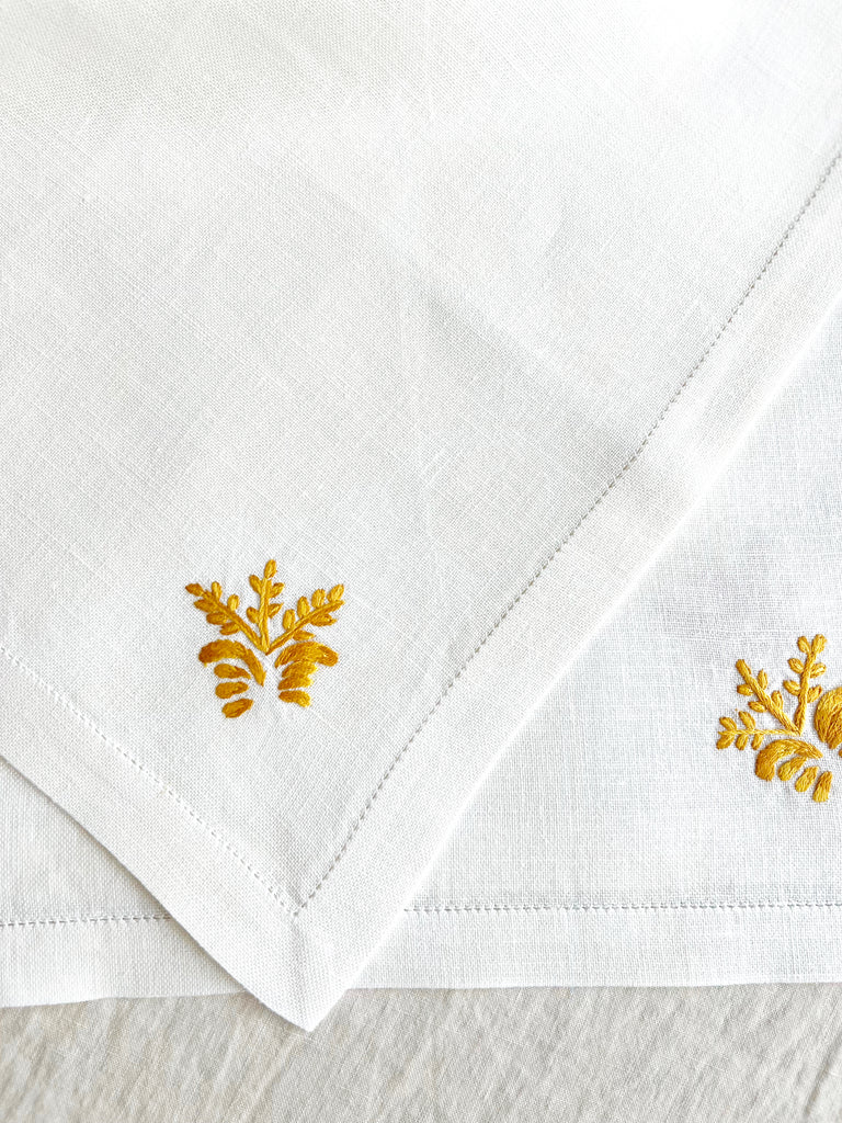 white hand embroidered linen napkins with gold corn stalk in corner 16 inches square detail view
