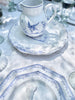 white serving tray with blue phoenix design in placesetting