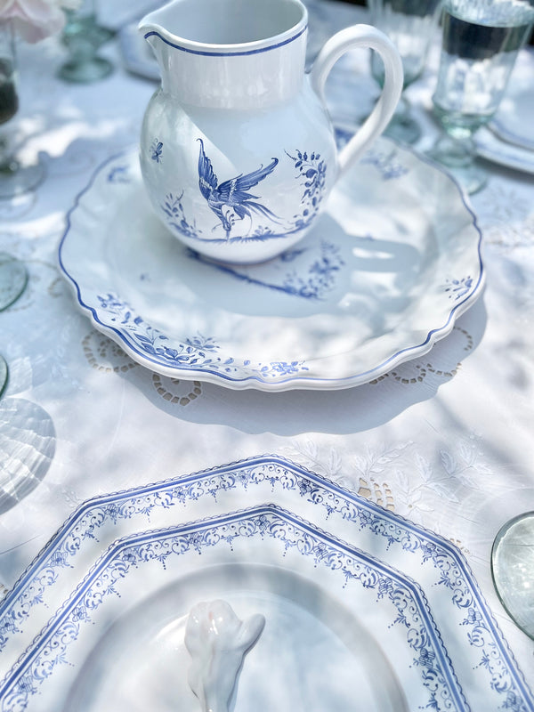 blue and white pitcher with blue phoenix design with placesetting