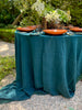 teal linen tablecloth with macrame trim with table setting side view