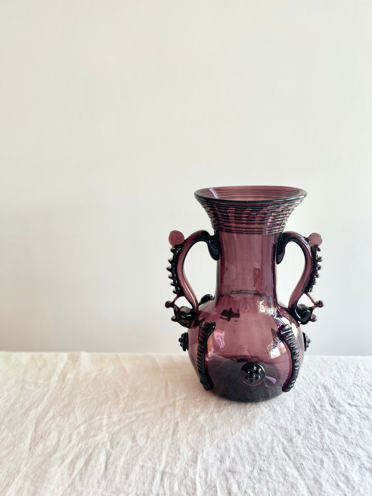 vintage plum-colored glass vase vaso petra on white table cloth