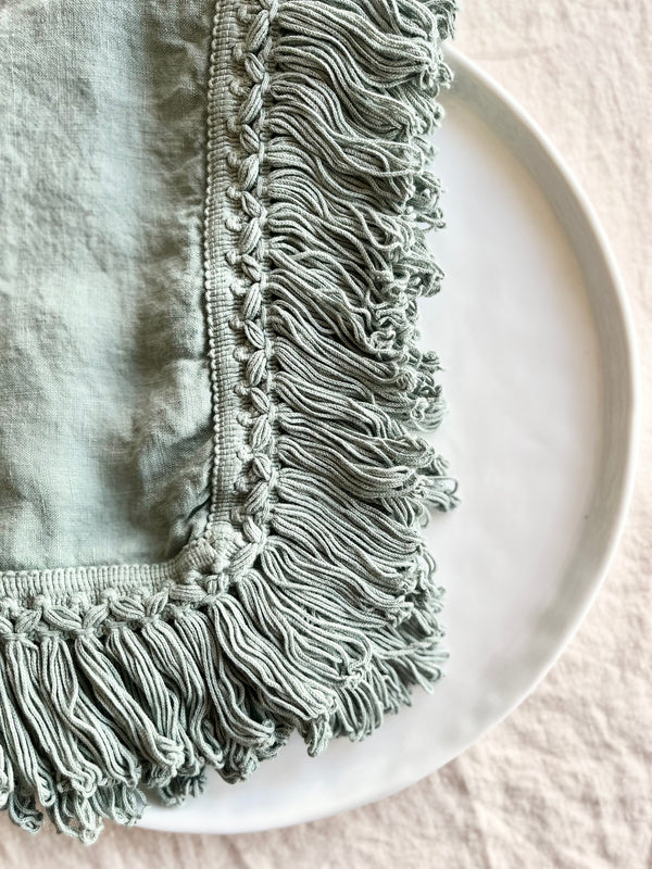 sage green linen napkins with fringe detail view