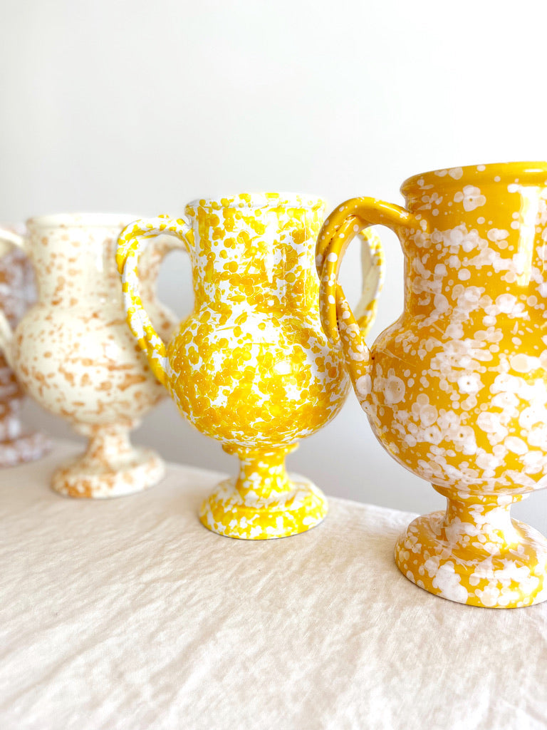 yellow amphora vase with white speckle pattern 13 inches tall in group with other color options
