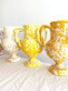 white amphora vase with yellow speckle pattern 13 inches tall in group with other color options
