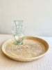 round woven tray thirty inches with clear vase