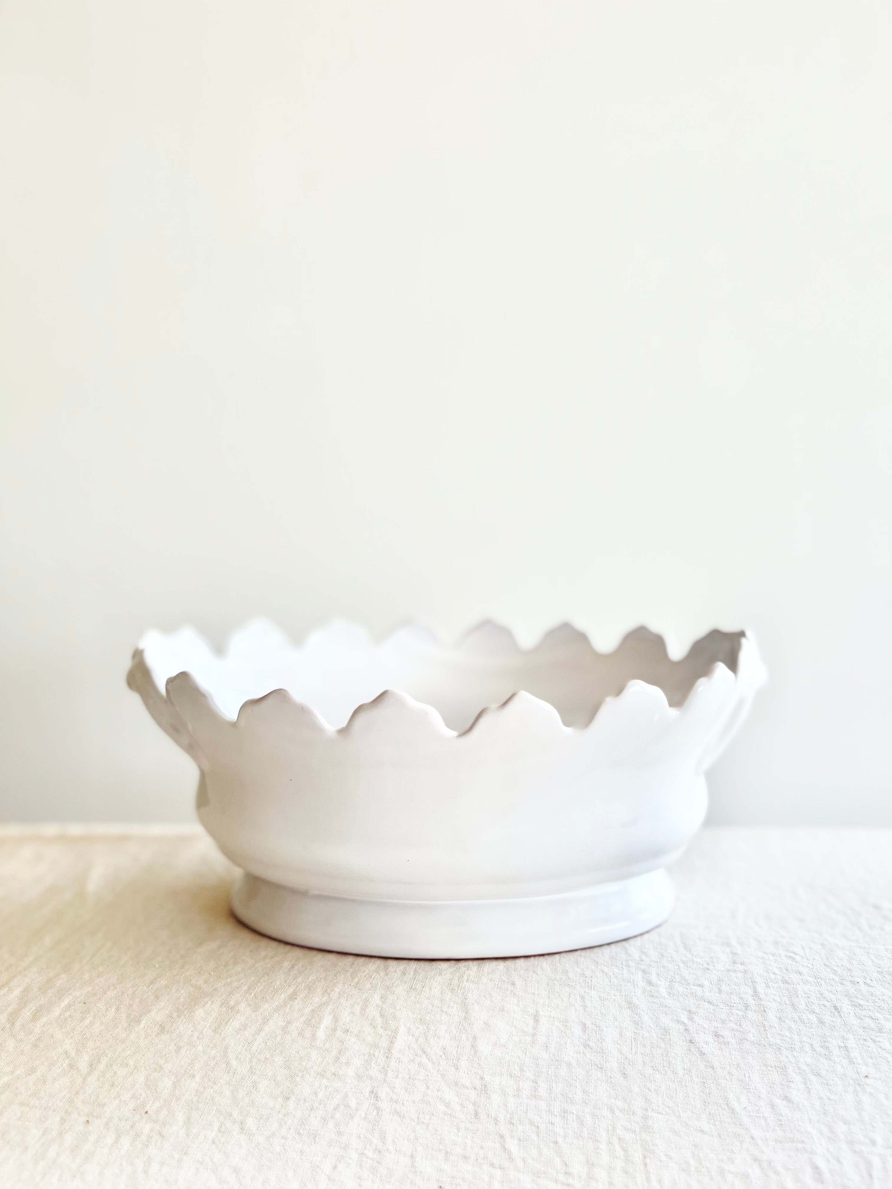 white jardiniere planter with scalloped edge