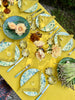 Yellow Milano Macrame Tablecloth shown on table outside from top view angle