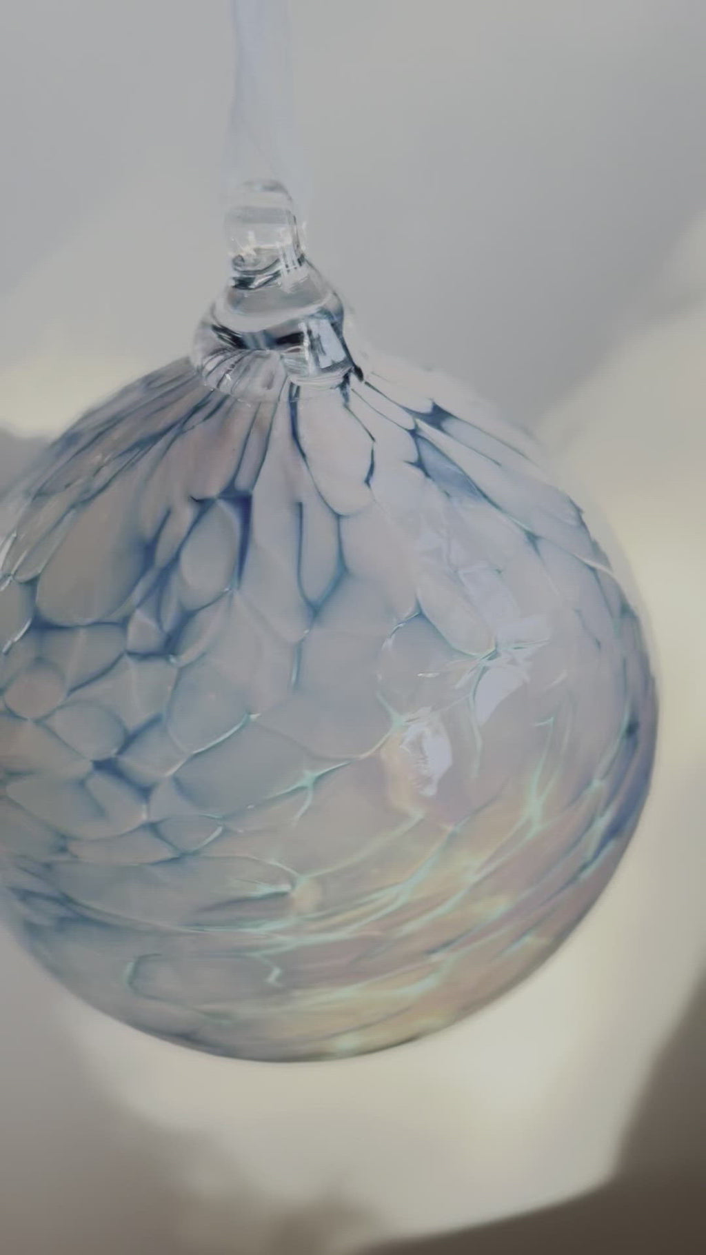 video of hand blown glass ornament blue and teal swirl pattern