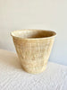 light brown hand woven wastebasket top view