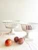 pair of two white openwork footed bowls