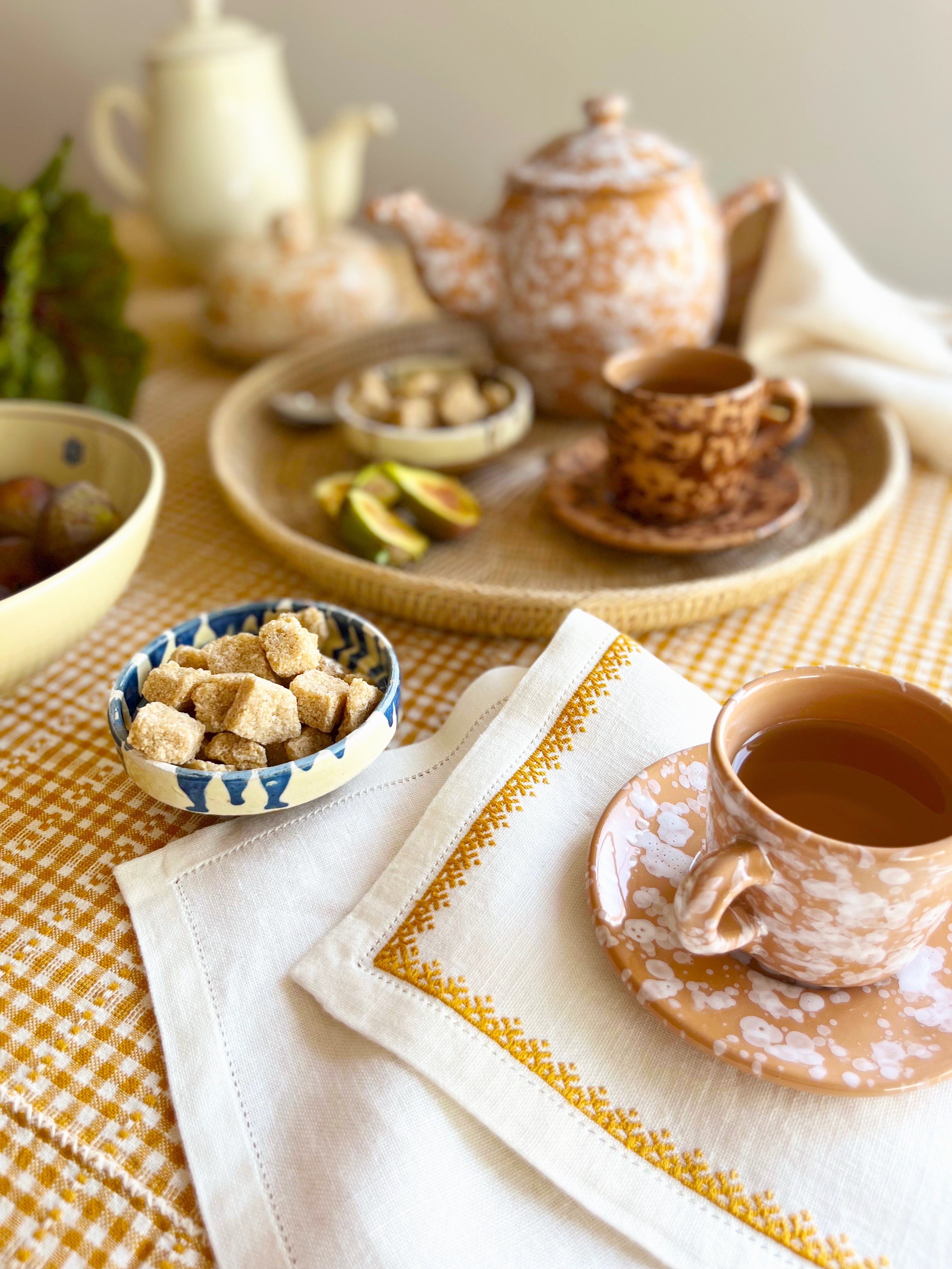 fasano espresso cup with splatter pattern in natural color on woven tray