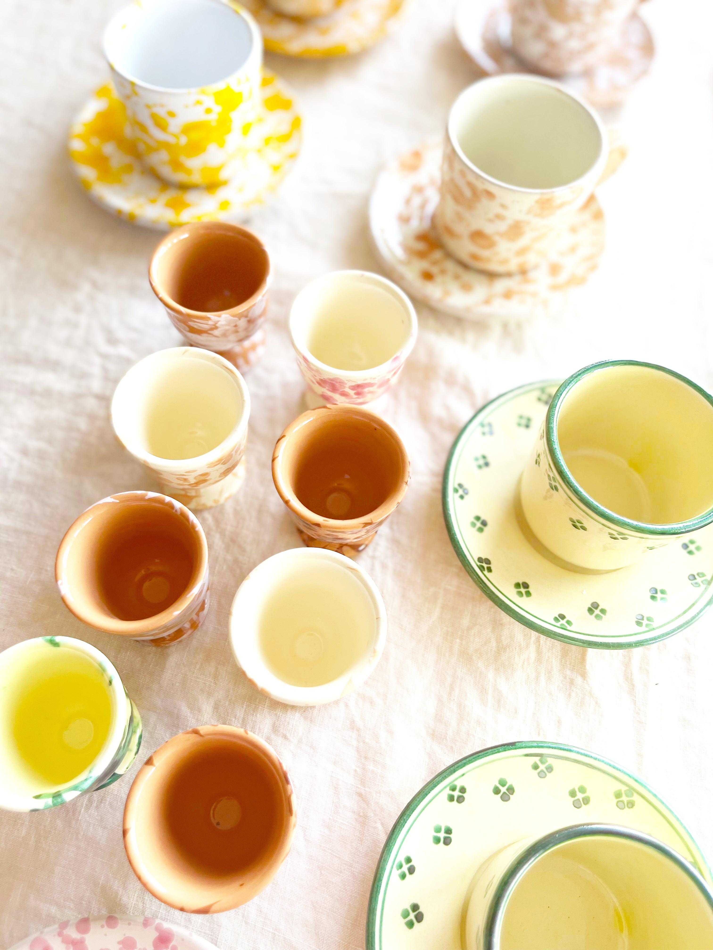 Rigo Stella Espresso Cup & Saucer yellow and green assorted on a table