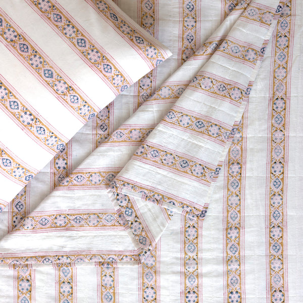 twin size white cotton quilt with gold, blue and pink floral stripes