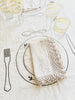 hand painted wine glass with two cream stripes on linen tablecloth