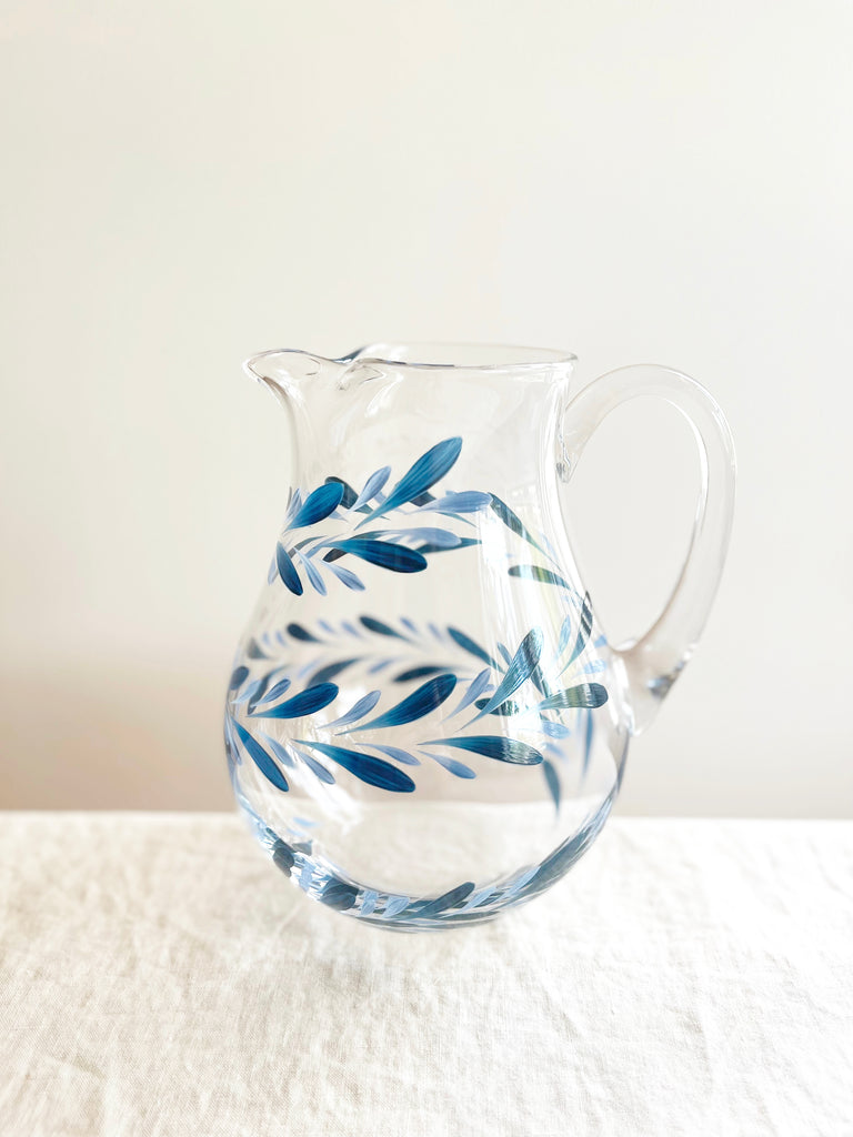 glass pitcher with hand painted blue leaf pattern 8 inches tall