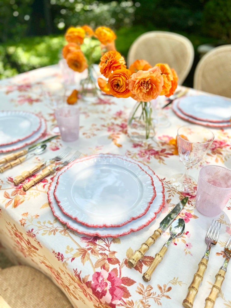 linen tablecloth with red climbing rose pattern with placesetting