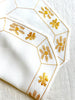 octagonal white linen placemat with gold embroidery 19.5" by 16" group of two