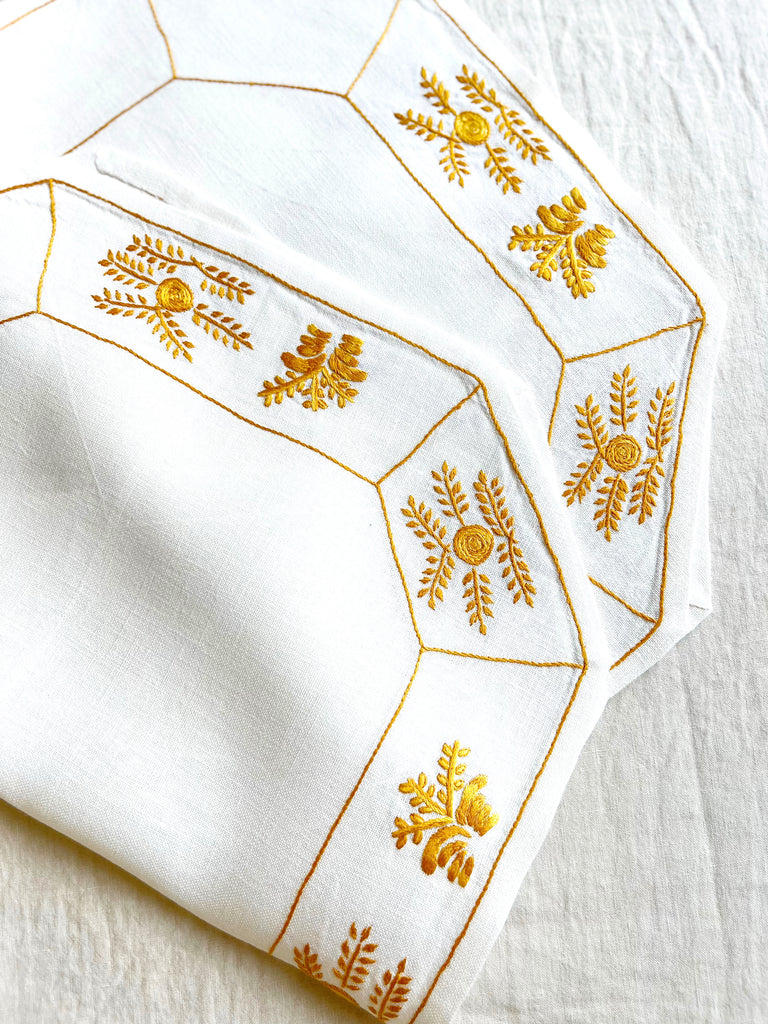 octagonal white linen placemat with gold embroidery 19.5" by 16" group of two