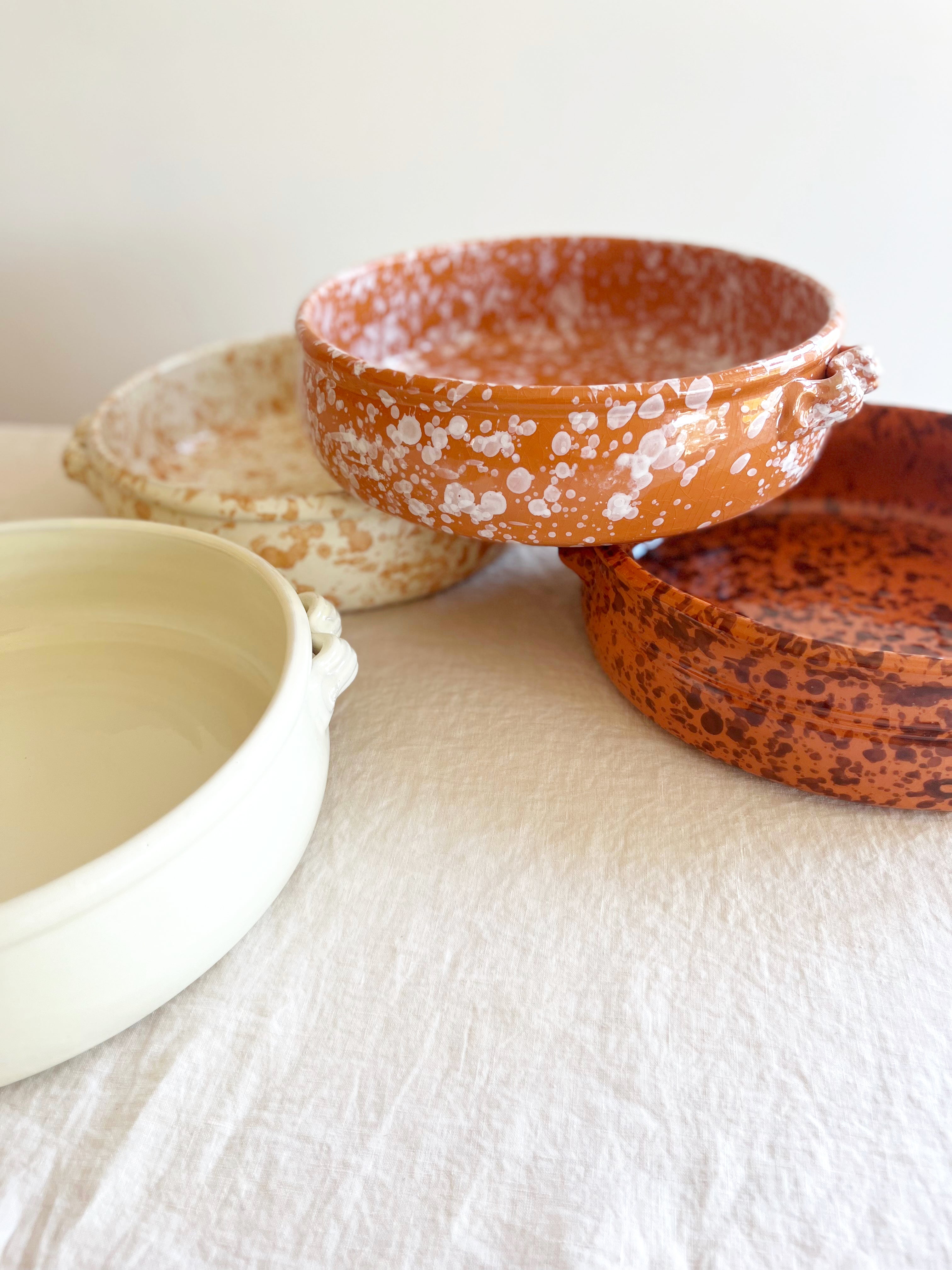 brown round oven safe dish with dark brown speckle pattern 12.5" diameter on white table