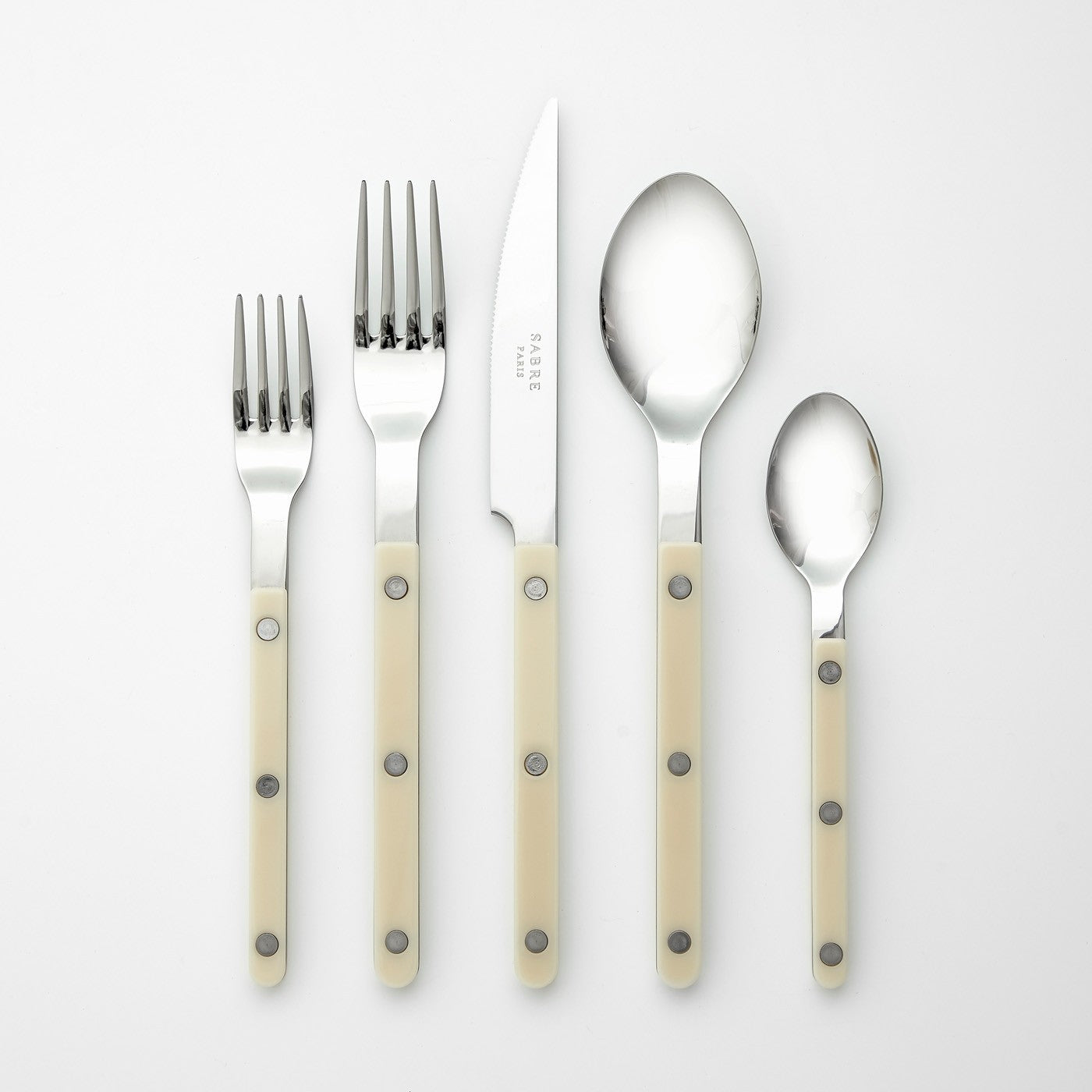 sabre stainless steel flatware set with cream resin handles