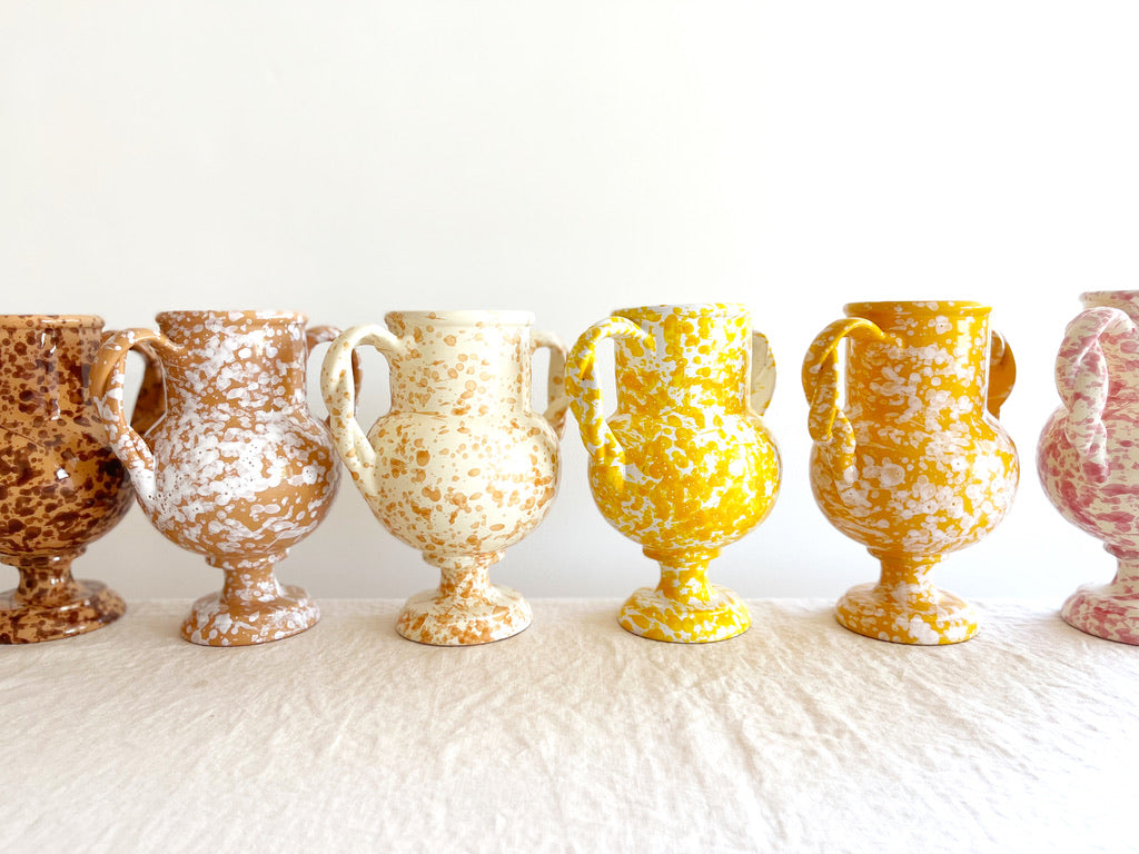 small yellow amphora vase with white speckle pattern 8.25 inches tall shown with other color options