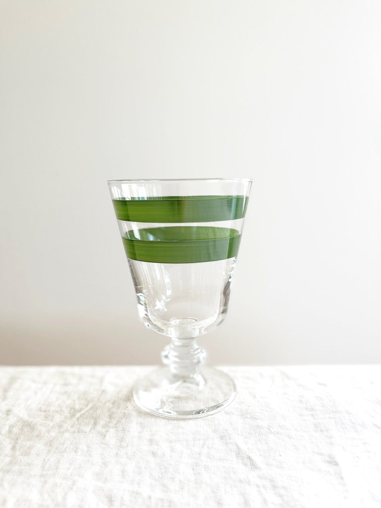 hand painted wine glass with two green stripes on white linen