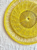 yellow round woven placemat detail view
