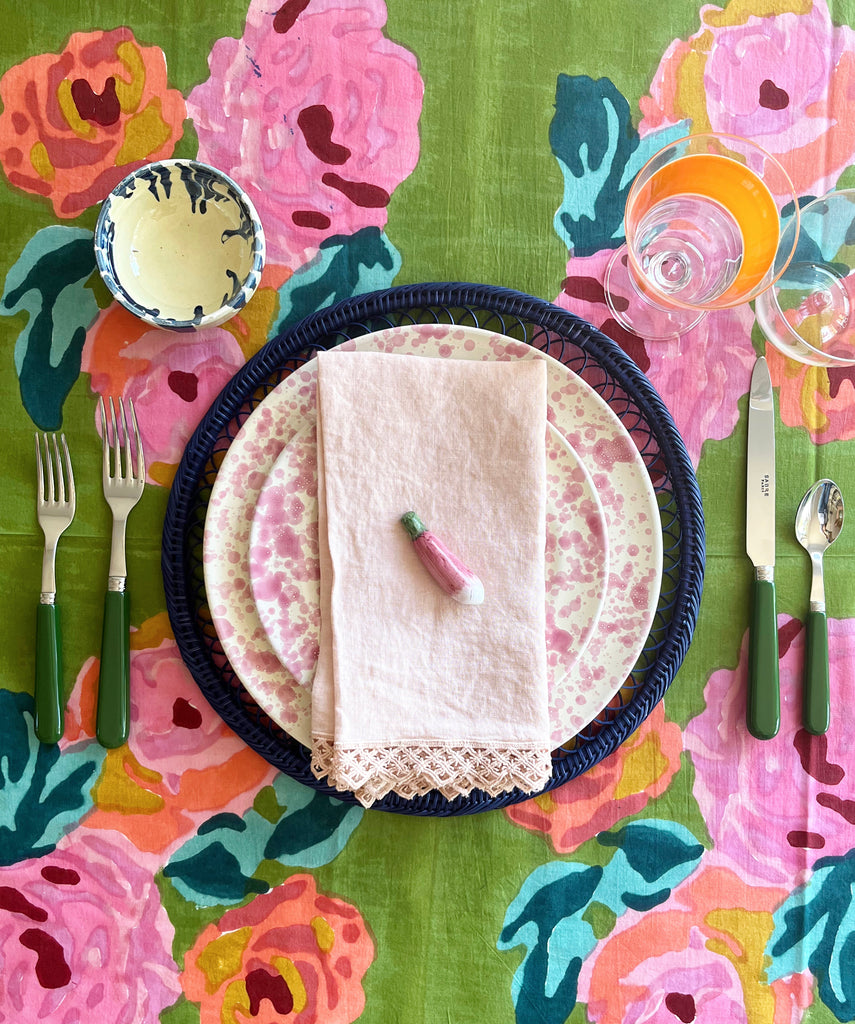 cream fasano dinner plate with pink speckle pattern with placesetting