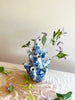 blue and white marble patterned tiered tulipiere 13 inches tall with purple flowers