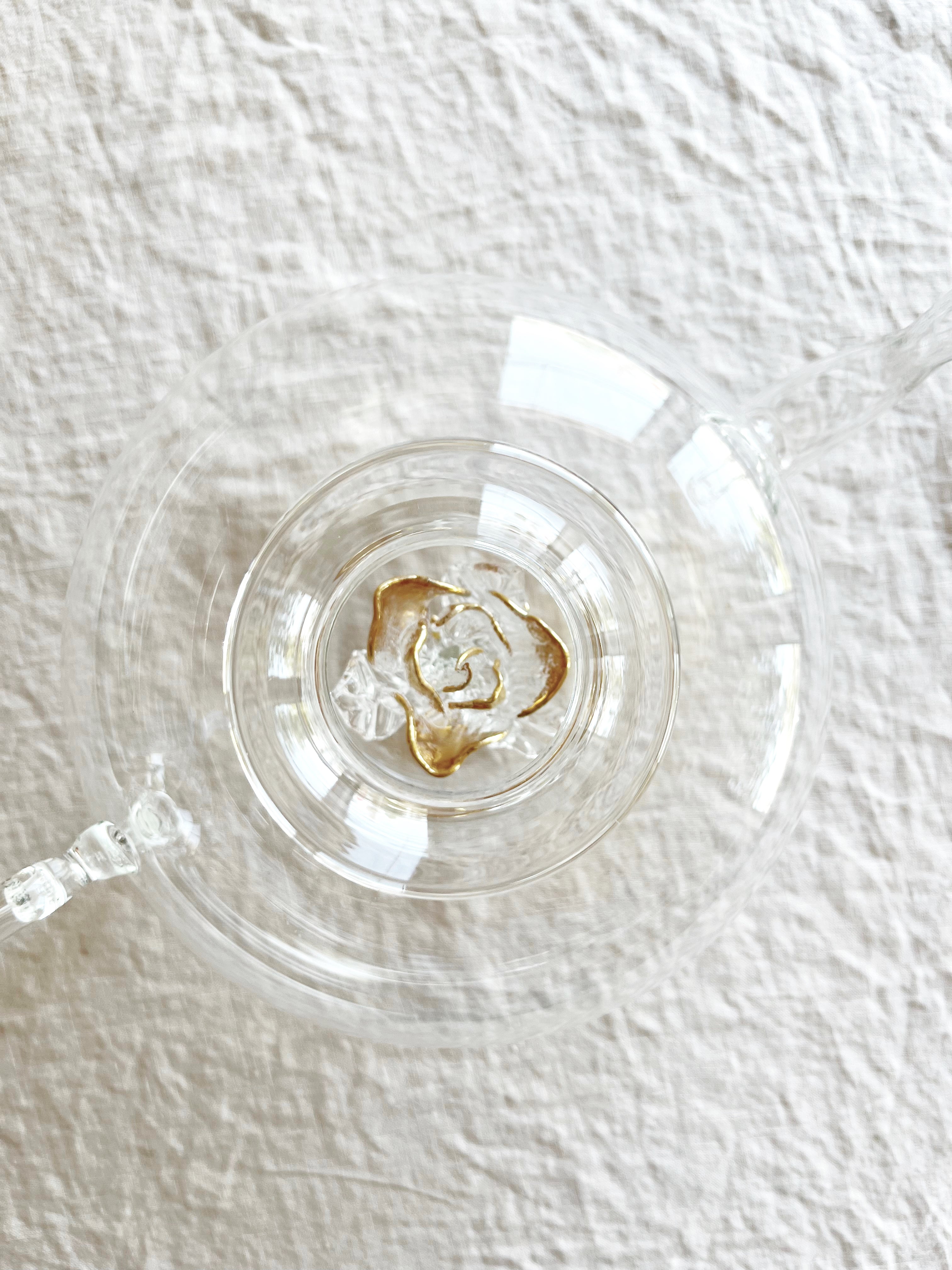 clear hand blown glass teapot with gold glass rose in bottom top view