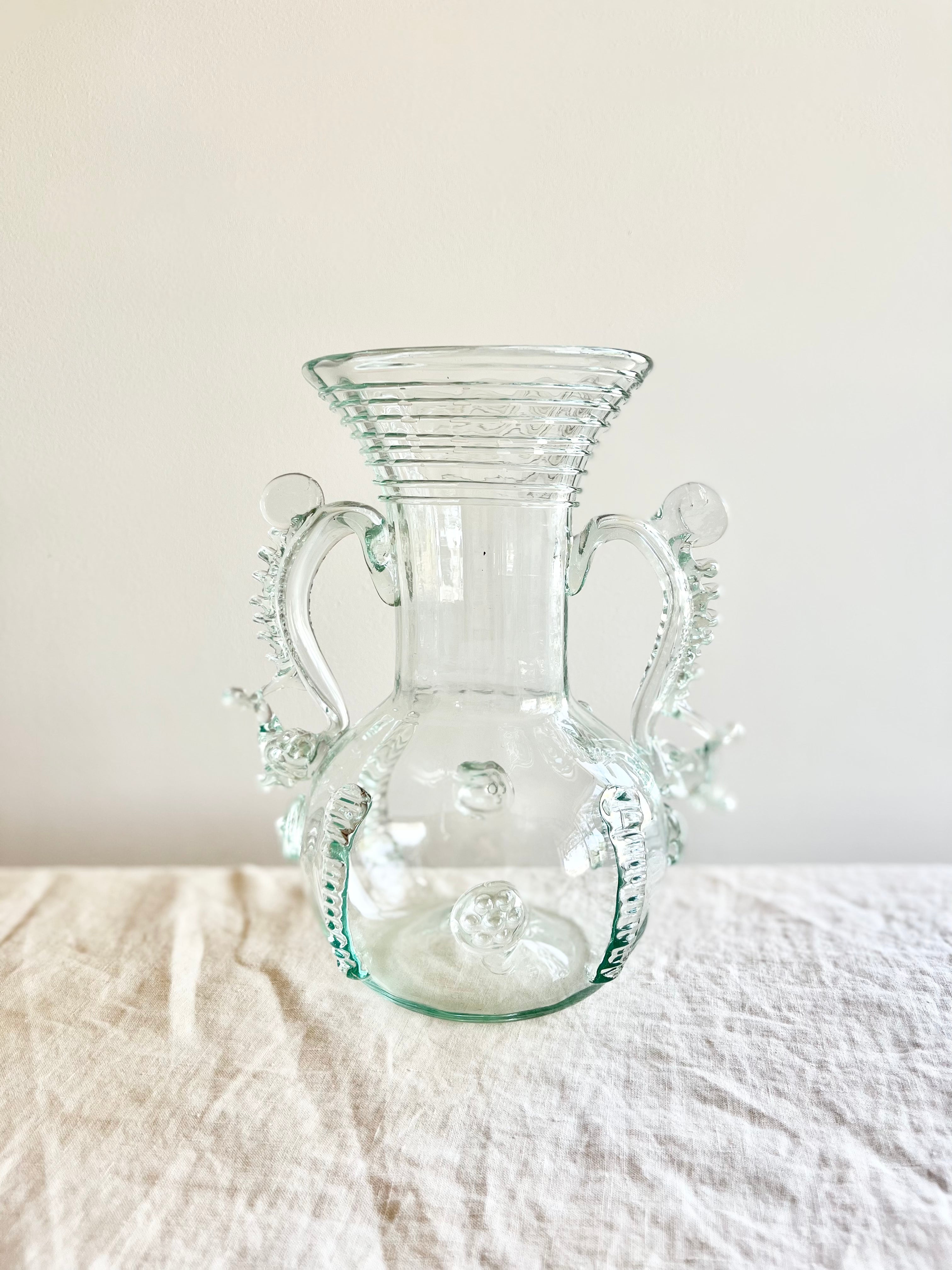 clear glass vase with two handles and clear glass stripes on neck 9.5 inches tall