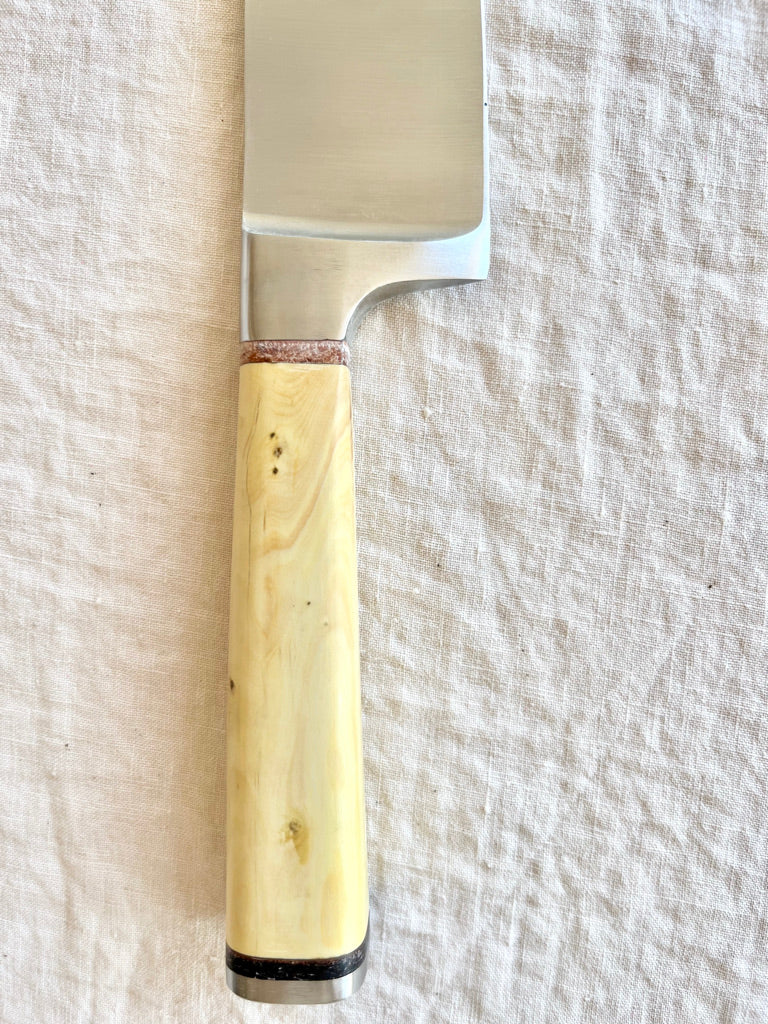 chef knife with boxwood handle on white table by palleras solsona handle detail