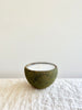 candle in moss covered terra cotta pot unlit