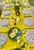 Yellow Milano Macrame Tablecloth shown on table outside with settings