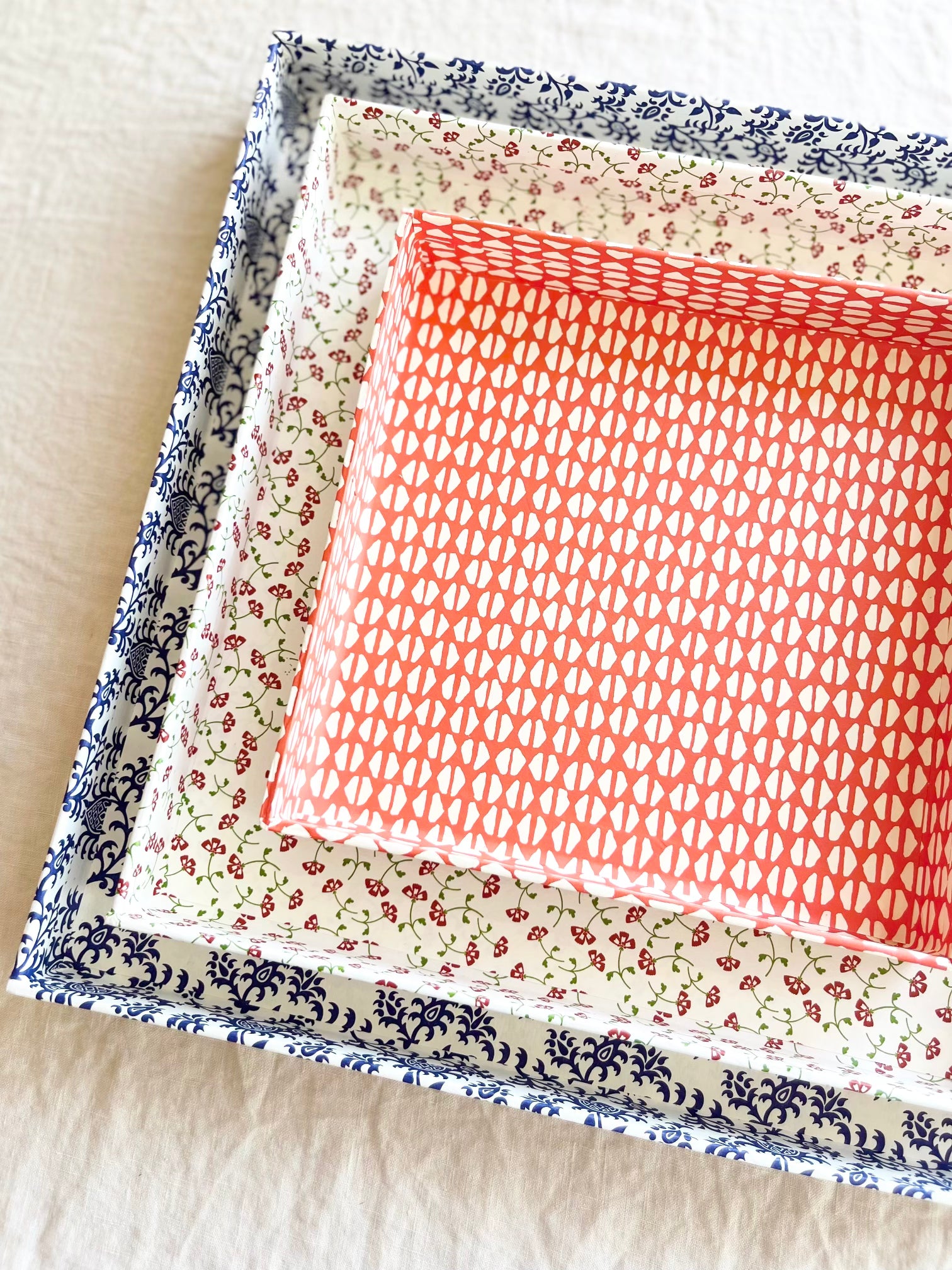 square white paper tray with red cherry print 11 inches nested with other trays
