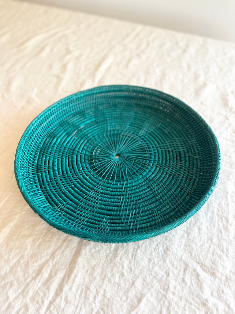 green round woven tray fourteen inches on white table