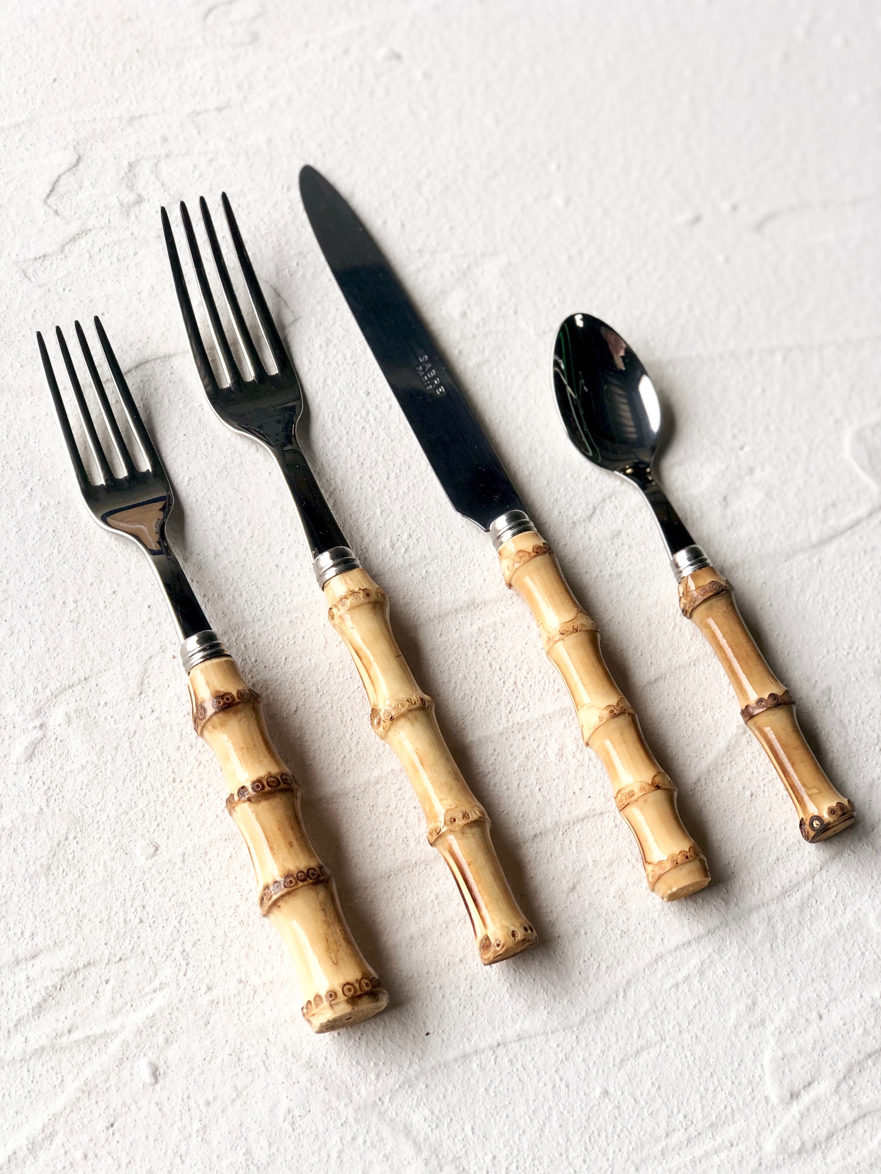 sabre stainless steel flatware set with natural bamboo handles on white table