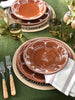 round placemat with burgandy stoneware