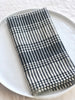 black and white striped cotton napkins 19" square folded on plate