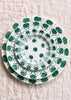 ceramic salad plate with green daisy pattern in place setting